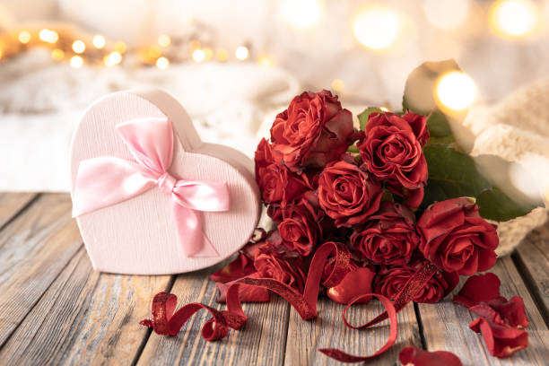 composition for valentine's day with a gift box and a bouquet of roses. - table wedding flower bow imagens e fotografias de stock