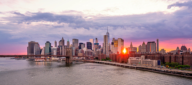 New York city skyline panorama in the evening. Aerial panoramic view of Manhattan illuminated skyscrapers and Empire state building after the sunset