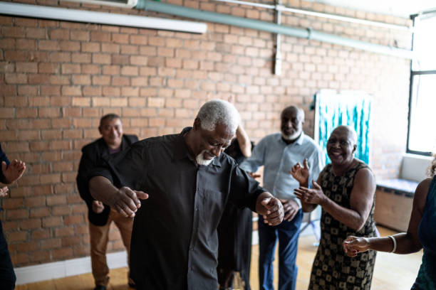 istock Senior man dancing with his friends on a dance hall 1448396056