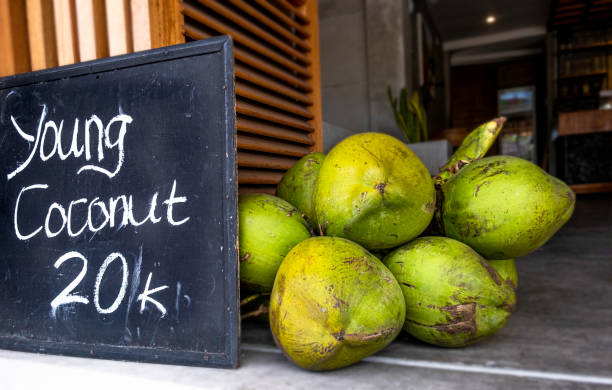 istock Young green coconuts in pile next to black chalk board sign 1448396942