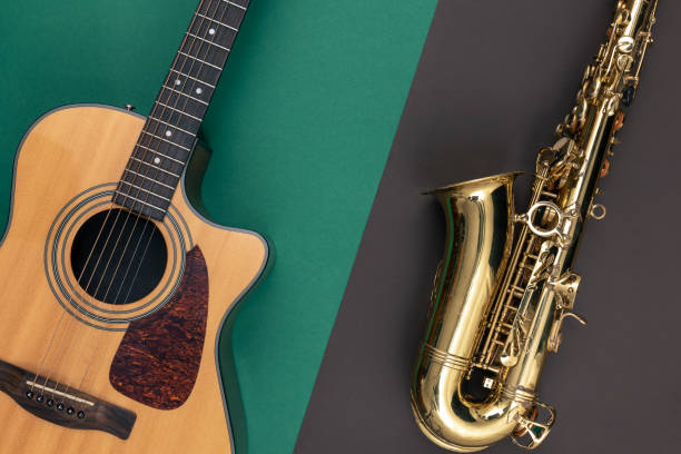 istock Guitar and saxophone on paper background, top view. 1448396956