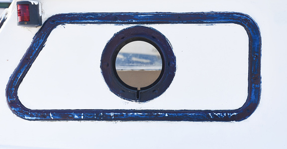 Boat closed porthole with vacation seascape view. the sea and sand can view from porthole. Boat porthole with beach view.