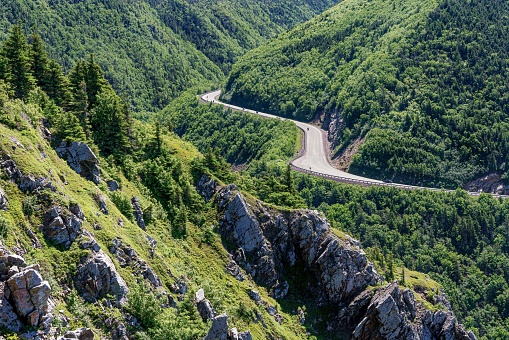 A scenic drive along Cabot Trail during springtime, through the forests and mountainous plateaus of Cape Breton Island in Nova Scotia, Canada.