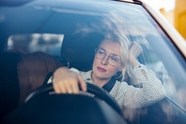Serious Businesswoman Driving Car