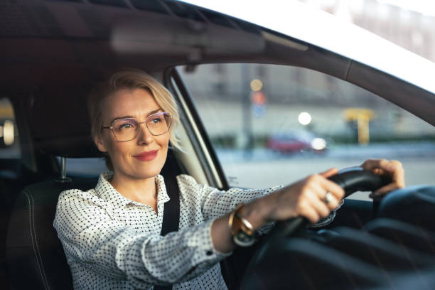 istock Smiling Businesswoman Driving Car 1448400401