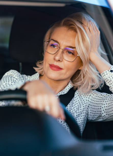 istock Smiling Businesswoman Driving Car 1448400408