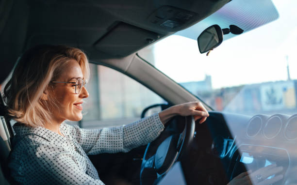 istock Smiling Businesswoman Driving Car 1448400427