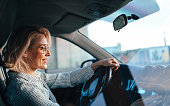 Smiling Businesswoman Driving Car