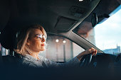 Happy Businesswoman Driving Car