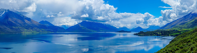Panoramic view of the snowcapped peaks surrounding the beautiful Lake Wakatipu in the south island of New Zealand