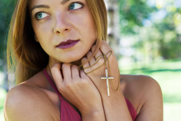 istock Religious young woman praying 1448406792