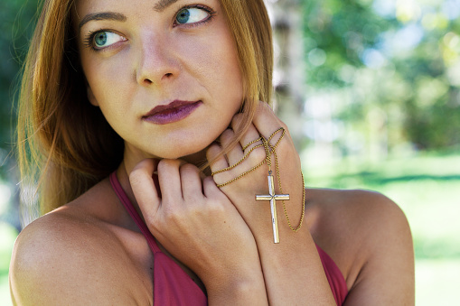 Religious young woman praying