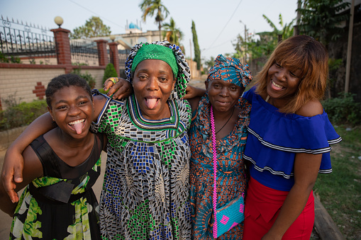 Four African women of different ages together laugh and make funny faces