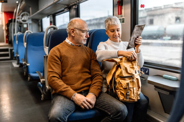 istock Cheerful mature couple traveling by train 1448407590
