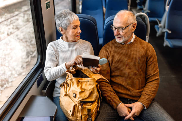 istock Cheerful mature couple traveling by train 1448407600