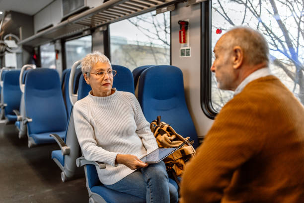 istock Senior couple using technology in train car.  Mature man and woman using digital tablet and smart phone. 1448408525