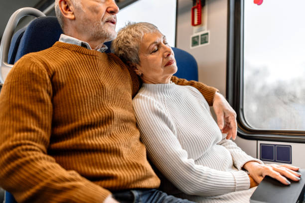 istock Senior couple enjoying long ride while napping and reading book 1448408686