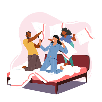 Family Characters Fight on Pillows. Happy Young Parents with Child Jumping on Bed in Bedroom and Hit Each Other