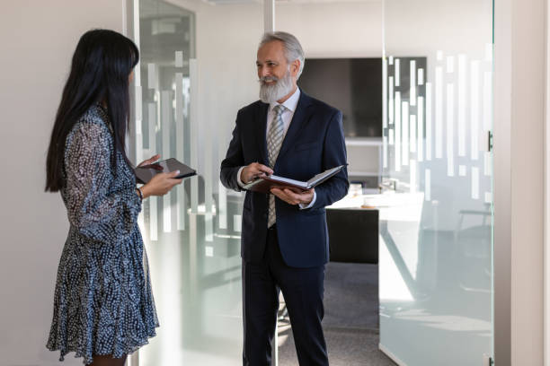 istock Formal talk between director and woman in office 1448409871