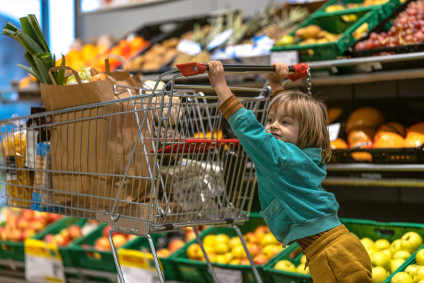 istock A mother with a child in a store with fresh vegetables 1448410090