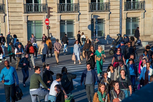 Paris, France - October 07, 2022: Crowd on a pedestrian crossing in Paris