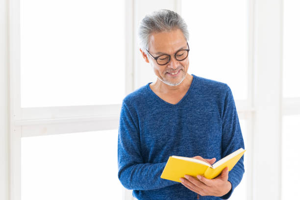 istock elderly man who reads a book, 1448419854