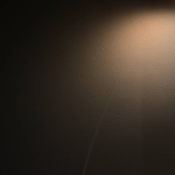 istock brown wall background with lights and black shadow 1448420551