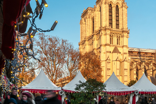 Christmas market near Notre Dame, with the cathedral in background. Paris in France.