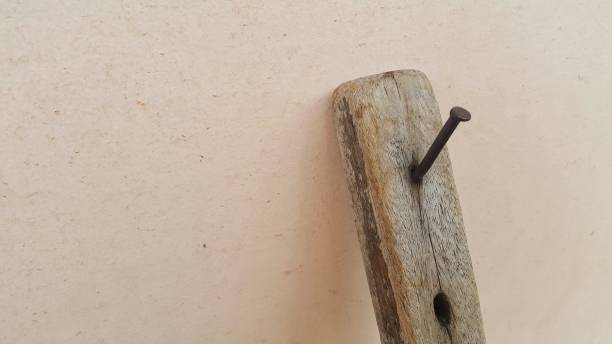 istock Rusty nail stuck in old wood 1448425841