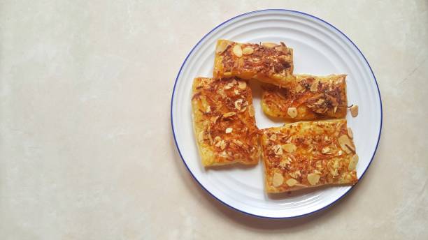 istock Delicious cheese almond cake pastry on white plate 1448426788