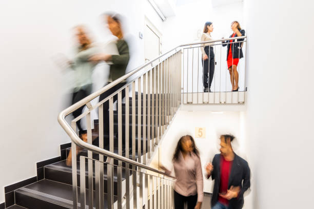 istock People walking up and down a staircase 1448431253