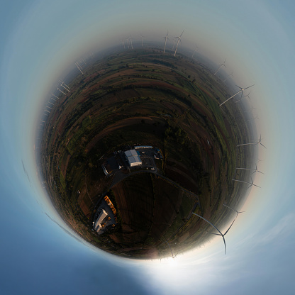 360 Degree Spherical panorama of Aerial view of Powerful wind turbine farm for pure energy production on beautiful clear blue sky with white clouds background.Renewable energy for sustainable development