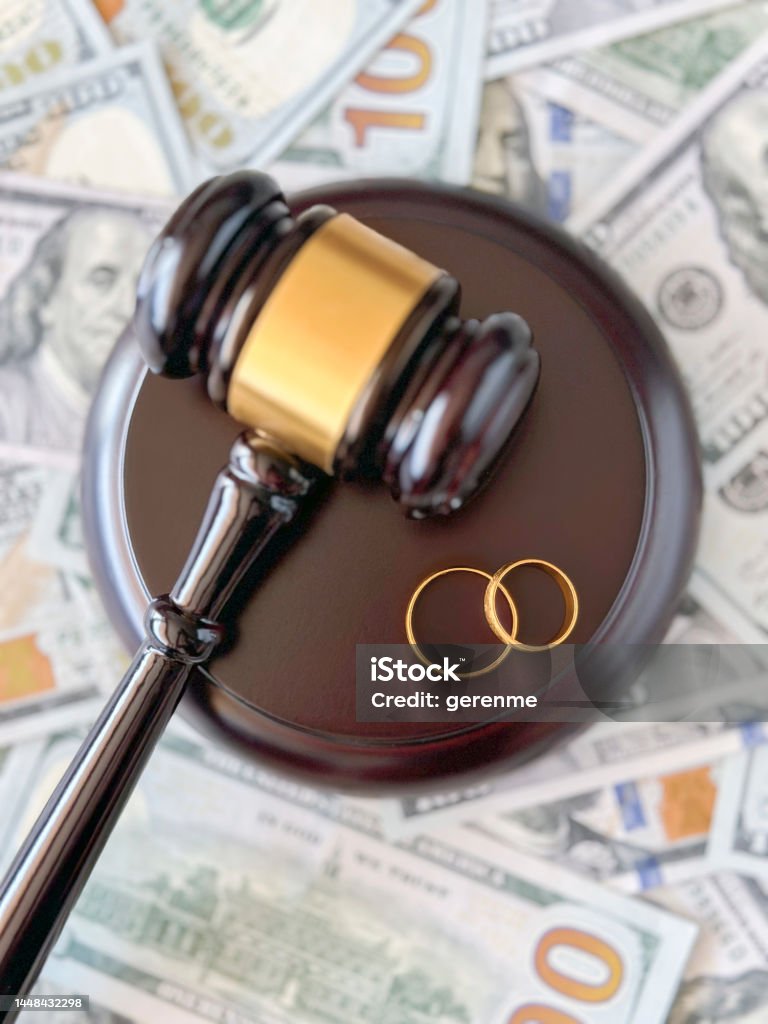 Judge gavel and wedding rings Judge gavel and wedding rings on dollar background American One Hundred Dollar Bill Stock Photo
