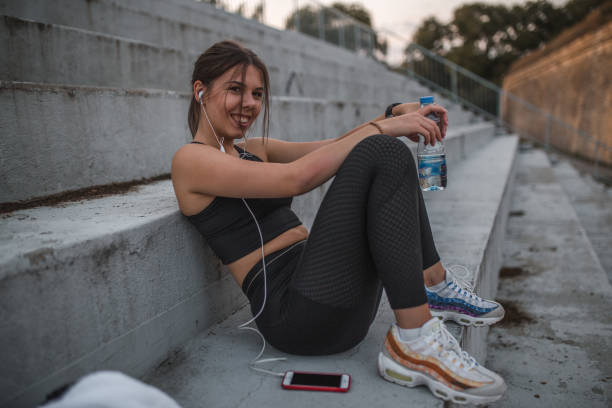 istock Happy woman sitting in the stands after training 1448432413