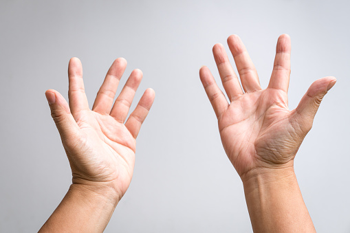 Pair of male hands raising up and reaching out gesture. Prayer, worship or crying for help gesture.