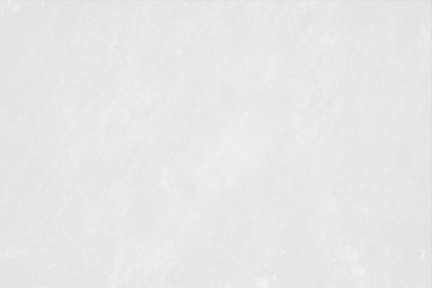 Very light grey or faded gray white coloured subtle scratches textured blank empty horizontal painted wall like vector backgrounds A horizontal vector background in subtle marble textured greyish white colour. Faint strokes design all over with ample copy space, no people and no text. Can be used as backdrops, wallpaper, laminate textures and designs. marble tile colors stock illustrations