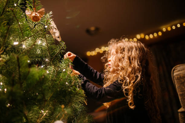 istock Girl Decorating Christmas Tree 1448438542