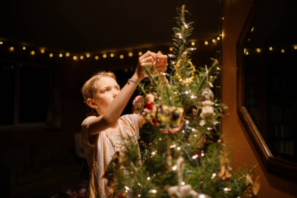 istock Girl Decorating Christmas Tree 1448438581