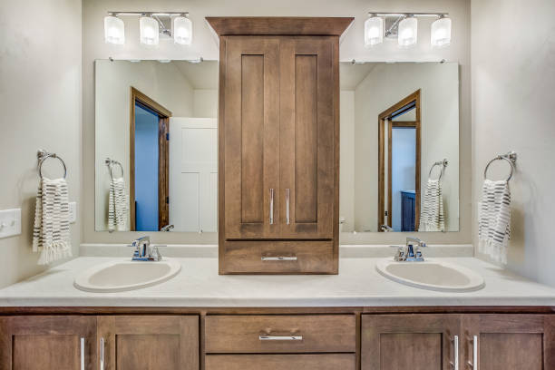 istock Cabinets separating mirrors and sinks in bathroom 1448439709