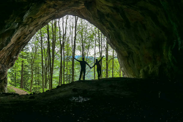 Interior view of couple holding hands at the entrance of the Drachenhoehle (Dragon Cave) in Pernegg an der Mur in Styria, Austria. Cave near Rothelstein in Mixnitz in the Grazer Bergland.Grotto,Europe