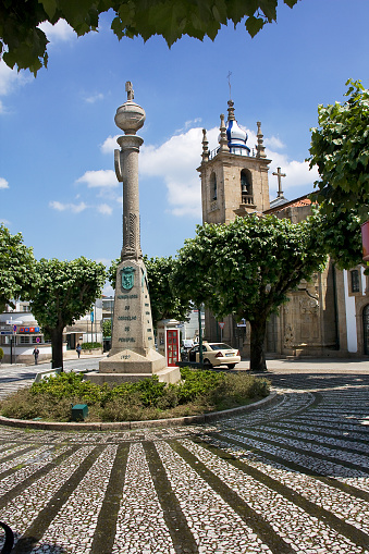 Town square, Misericórdia church stone, obelisk  and bell tower, Penafiel, Portugal. 17th century. Ornamental cobblestone.