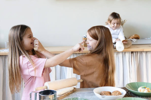 istock Children cheerfully cook and play in the kitchen 1448449721