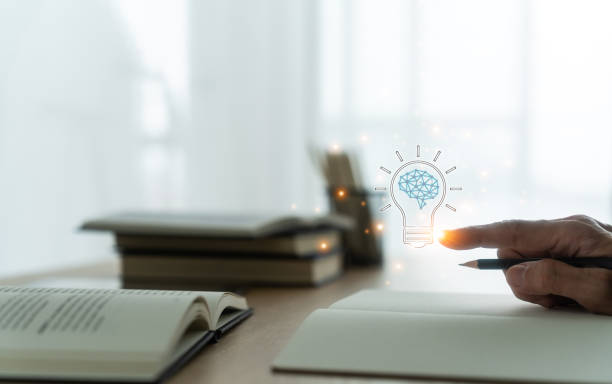 istock Student holding bright lightbulb and reading book or textbook. Success idea of education learning and studying. Businessperson skill training course. Knowledge and cognition concept 1448450469