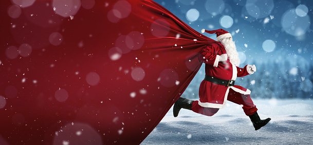 Santa Claus pulling huge red gift bag with full of christmas presents. Isolated on white background.