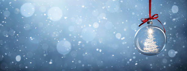 istock Glowing christmas tree in a bauble over snowy background 1448452197