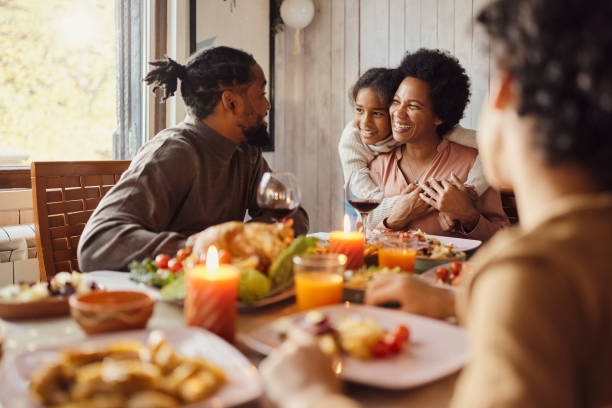 istock Happy black family talking during lunch in dining room. 1448455036