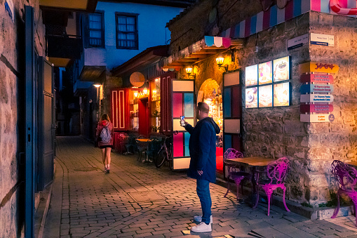 Antalya, Turkey - 12/03/2022: A street photo showing the illuminated streets and classical architecture of Antalya Old Town as New Year's Eve approaches.