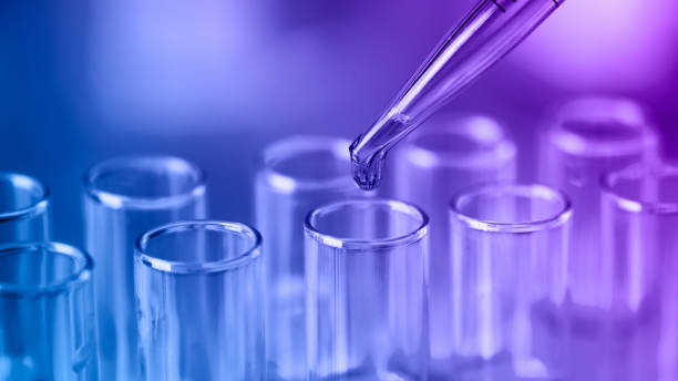 istock Test tubes with blue liquid water samples and pipette. Pipette dropping sample into test tube. 1448459568