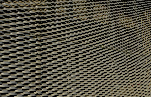 istock steel cladding of a building with a expanded metal lattice structure. galvanized gray nets protect the industrial building. Blue sky in contrast to a silver background, staircase, laboratory, science 1448459657