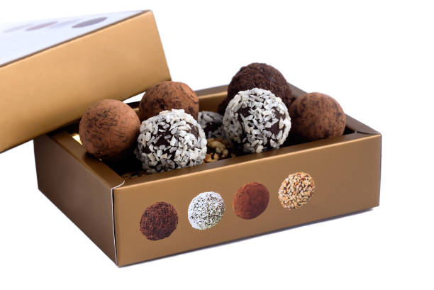istock In a gift box a set of chocolate sweets with culinary sprinkling.White isolated background. 1448460780
